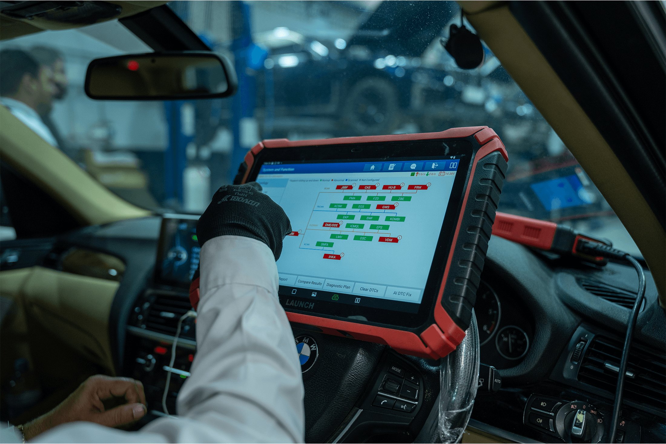 A luxury SUV in the diagnostic bay under scanning light