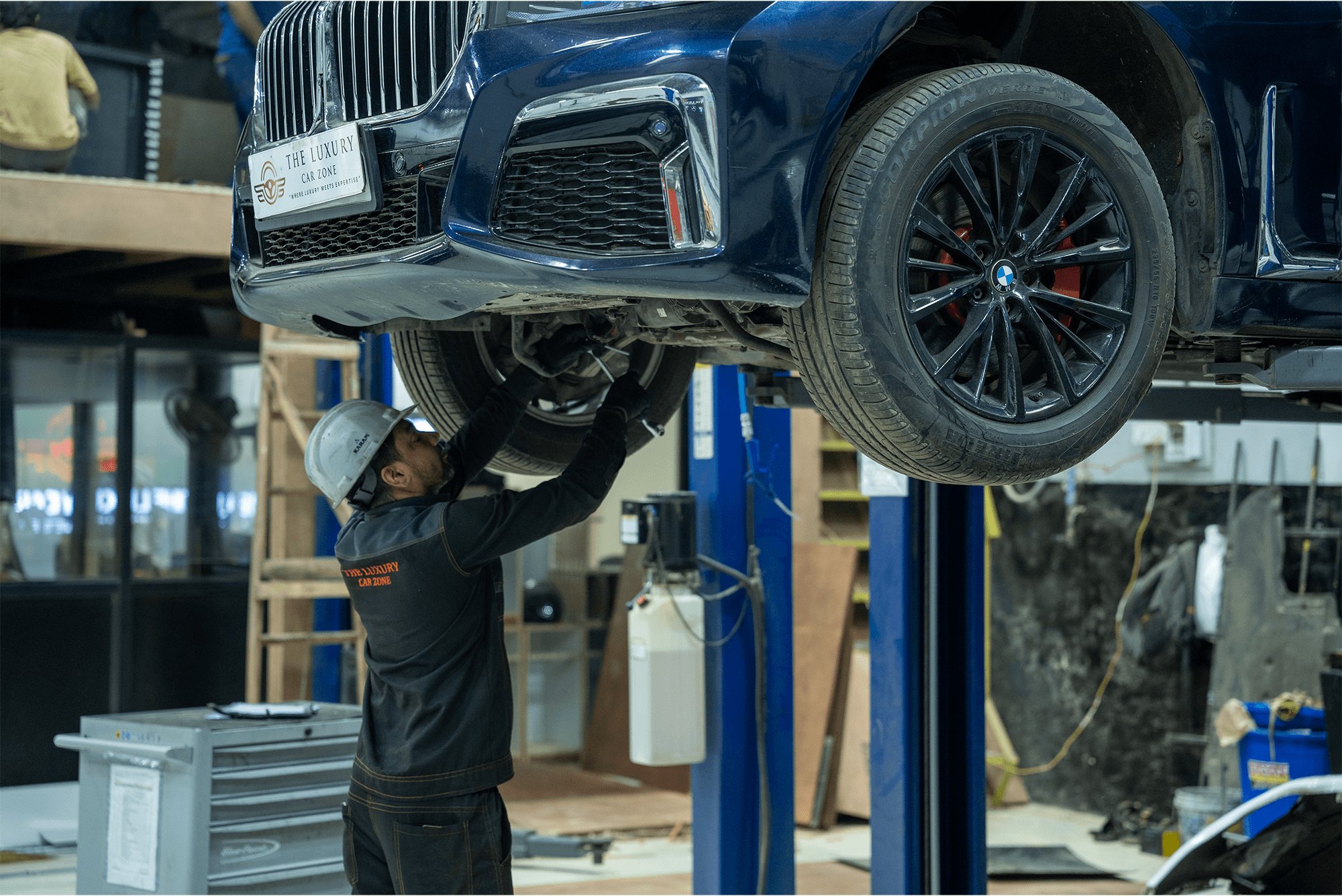 A BMW raised on a lift for scheduled maintenance